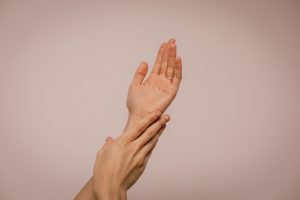 Soft hands in front of a pink background